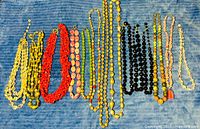 All necklaces laid out on blue fabric