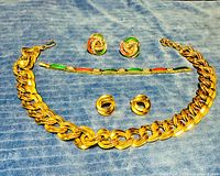 All jewelry items laid out on blue fabric