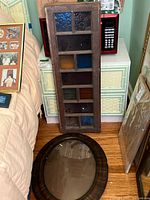 Overall view of both the oval frame and the stained glass panel