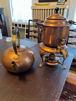 Teapot and samovar side by side on table
