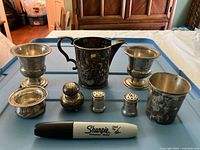 Full lot view including pair of shakers for scale