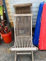 Front view of weathered teak folding slatted chair