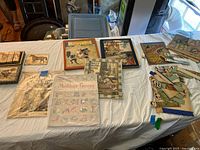 Overview of books, flashcards, Mother Goose sheet and puzzle on table