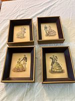 Top view of four framed prints in lot