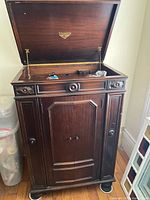 Full view of open-lid Victrola Credenza 315 cabinet on wheeled dolly