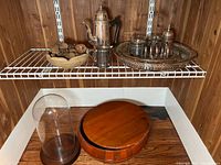Overall lot on shelving: coffee pot, creamer, trays, glasses, toast rack, wooden bowls, cloche
