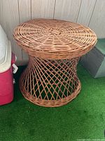 Side view of rattan drum side table showing woven base and top