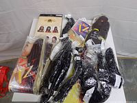 All hair extension packs and boxed wig on table