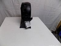 Side profile showing thickness and power cord