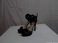 Full side view of both heels showing platform, heel height and ankle strap