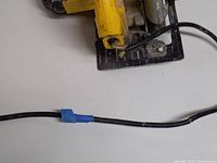 Power cord with blue tape repair and fraying