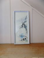 Full view of framed sumi-e ink and watercolor painting leaning against wall