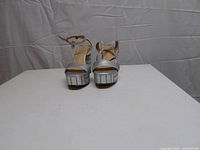 Front view of silver platform heels showing toe area and block heels