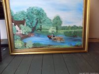 Front view of river cottage landscape painting in gilt frame