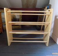 Front view of solid wood drying rack showing five dowel bars and side panels