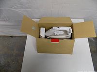 Iron inside original cardboard box with cord and paperwork