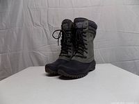 Three-quarter left view of both boots showing uppers, laces, and soles