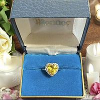Ring in Monaco box showing heart yellow stone and halo