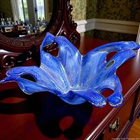Top view of blue Murano glass vase on wooden surface