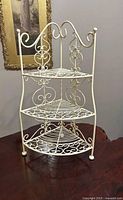 Full view of three-tier white cast iron corner plant stand