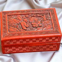Top view of cinnabar box showing carved landscape scene and Greek key border