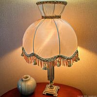 Boudoir lamp with onyx base and matching vase displayed on table