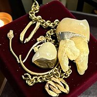 Scrap gold pieces on red background showing overall items