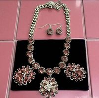 Necklace and earrings laid out on black velvet showing overall design and clasp