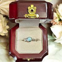 Ring in presentation box showing larimar stone and silver band