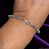 Bracelet on wrist showing scale and design