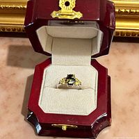 Ring in hinged burgundy presentation box
