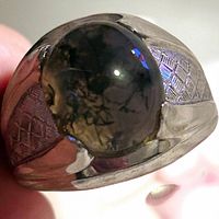 Close-up of jade cabochon and engraved shoulder detail