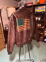 Rear view showing large US flag graphic and overall leather condition