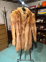 Front view of fox fur coat on stand