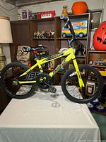 Left side view of yellow Movelo Rush 18" BMX bike