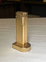 Front view of gold-tone ribbed Cygnus table lighter