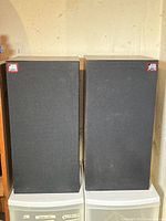 Front view of both dB Plus 880e speakers with grilles in place