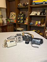 Group shot of all four cameras with straps and cases