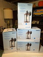 Four sealed Kichler Barrington lantern boxes stacked