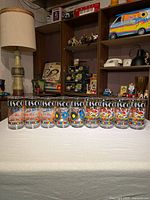 Nine disco themed glasses lined up on table