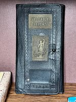 Front view showing embossed title, company name and figure