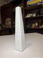 Full side view of tall textured porcelain vase
