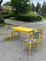 full set showing table and four chairs outdoors
