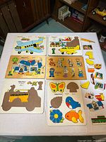 All five puzzles laid out with loose pieces