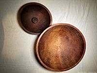 Top view of both wooden bowls showing size difference and interior grain