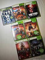 Seven Xbox 360 game cases laid out