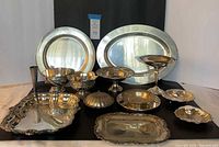 Group shot of all 13 silver pieces on black backdrop