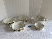 Full view of five CorningWare dishes and two lids
