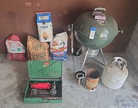 Overview of grill, stove, fuel bags, propane tank, chimney starter
