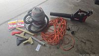 Group view of vacuum, blower, extension cord, hoses, wands, nozzles, filter bags